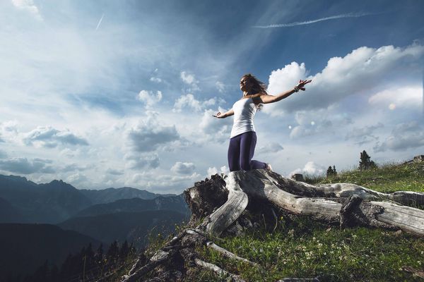 Frau beim Yoga vor Bergpanorama